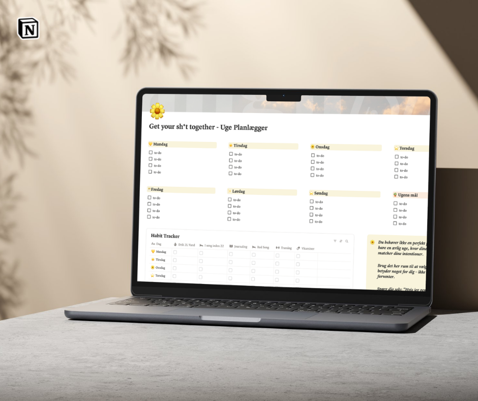 Laptop displaying a to-do list app on a wooden surface with a blurred background